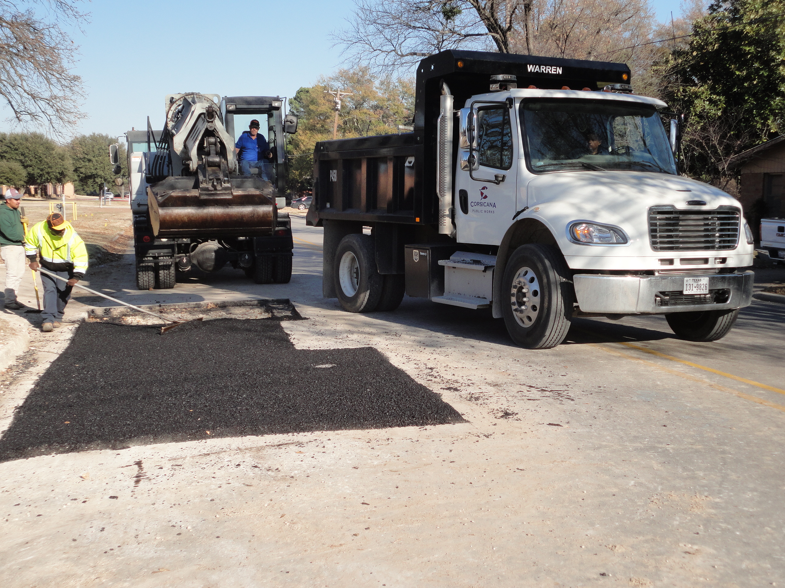 City employee repairing pothole