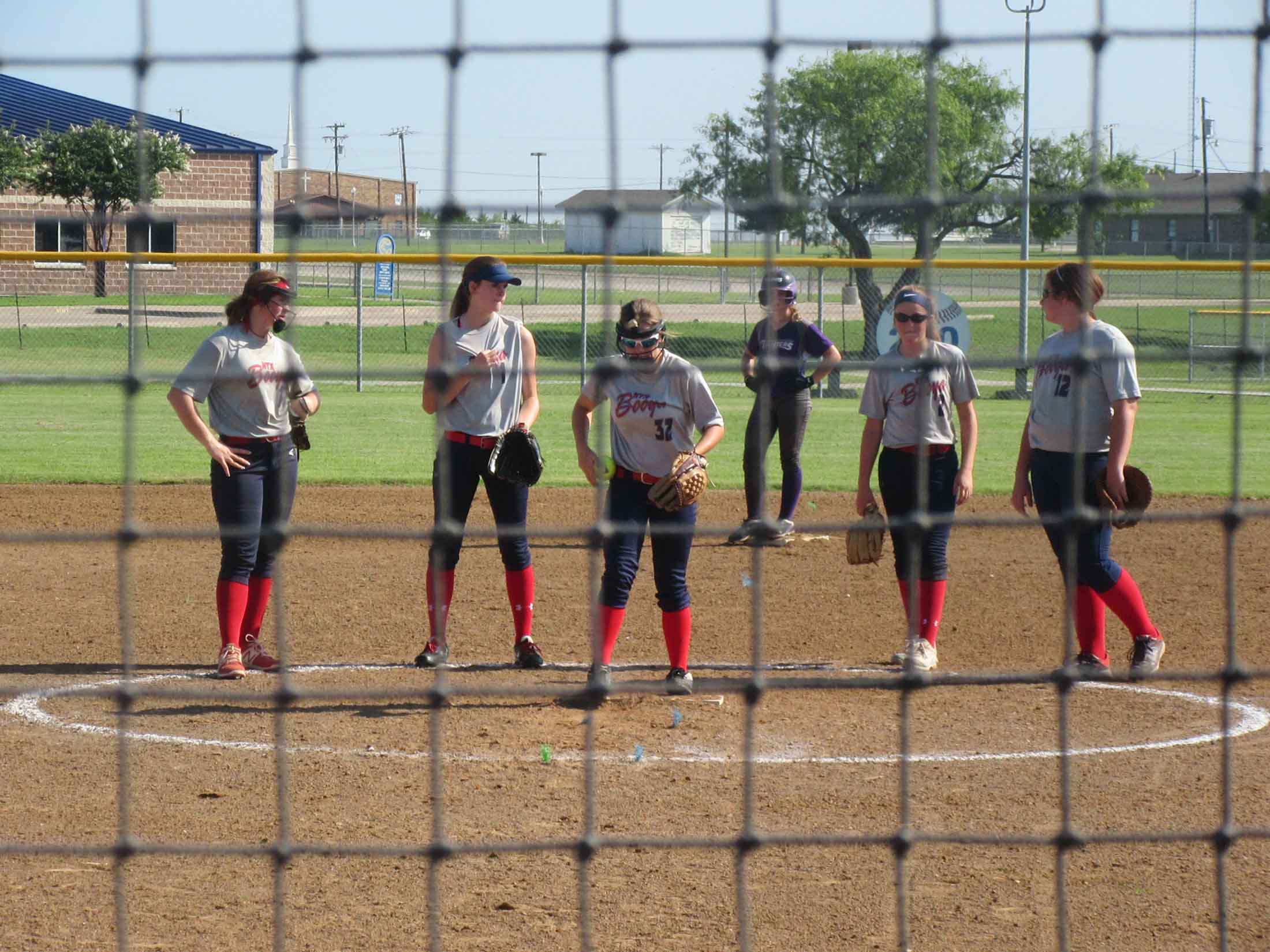 Girls team meeting at the pitcher's mound
