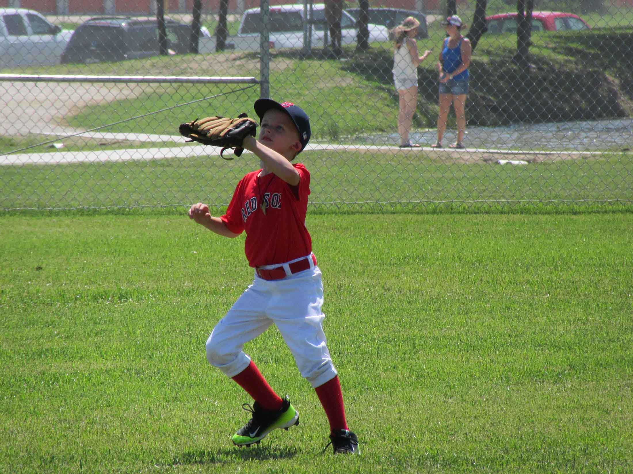 Boy in red shirt catching a ball