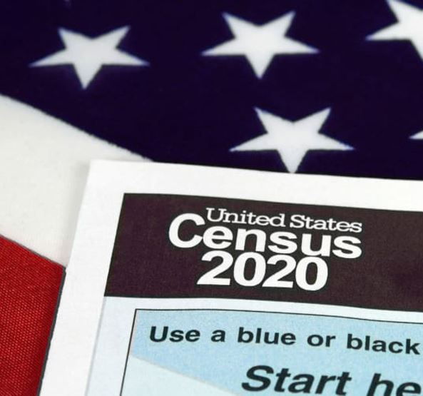 Census 2020 Form with American Flag in Background